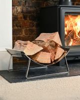The Bright Chrome Curved Contemporary Log Holder on a Black Stone Hearth in a Contemporary Living Room - Digital Illustration 