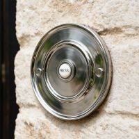 The Bright Chrome Sovereign Park Classic bell push on a Stone Wall of a Traditional Home - Digital Illustration