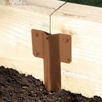 The Brown Railway Sleeper Straight Inline Spikes - Single in the Ground next to a Railway Sleeper Planter