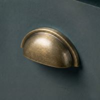 The Burnished Brass "Stratford" Traditional Cup Handle Mounted on a Wooden Blue Kitchen Cupboard Drawer - Digital Illustration The Burnished Brass "Stratford" Traditional Cup Handle Mounted on a Wooden Blue Kitchen Cupboard Drawer - Digital Illustration