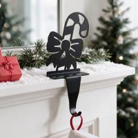 The Candy Cane Stocking Holder on a White Mantelpiece with a Christmas Tree Behind - Digital Illustration The Candy Cane Stocking Holder on a White Mantelpiece with a Christmas Tree Behind - Digital Illustration