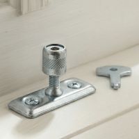 The Casement Stay Locking Pin in Front of a Wooden Window Frame in a Country Home in a Zinc Plated Finish - Digital Illustration The Casement Stay Locking Pin in Front of a Wooden Window Frame in a Country Home in a Zinc Plated Finish - Digital Illustration