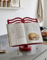 The Cast Iron Cook Book Stand in a Red Finish Holding a Recipe Book in a Modern Kitchen - Digital Illustration The Cast Iron Cook Book Stand in a Red Finish Holding a Recipe Book in a Modern Kitchen - Digital Illustration