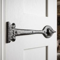 The Cast Iron Leaf Inspired Door Hinge Fitted onto a White Door to give a Traditional Feel - Digital Illustration 