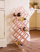 The Copper "Geometric Grid" Wine Rack Shown Supporting Wine Bottles in a Contemporary Countryside Kitchen - Digital Illustration The Copper "Geometric Grid" Wine Rack Shown Supporting Wine Bottles in a Contemporary Countryside Kitchen - Digital Illustration