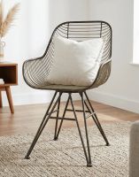 The Curved Industrial Wire Metal Chair Shown with a Cushion on it in a Living Room Interior - Digital Illustration The Curved Industrial Wire Metal Chair Shown with a Cushion on it in a Living Room Interior - Digital Illustration