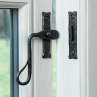 The Curved Shepherds Crook Bees Wax Window Fastener Fitted on a White Painted Window Frame - Digital Illustration The Curved Shepherds Crook Bees Wax Window Fastener Fitted on a White Painted Window Frame - Digital Illustration