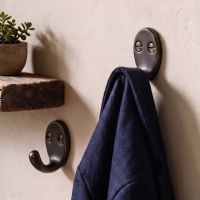 The Dark Aged Bronze Single Pronged Coat Hook Shown as a Pair Used to Hang a Blue Coat - Digital Illustration 