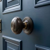 The Dark Bronze Ridged Pattern Centre Door Knob on a Blue Front Door to a Grand Home - Digital Illustration The Dark Bronze Ridged Pattern Centre Door Knob on a Blue Front Door to a Grand Home - Digital Illustration