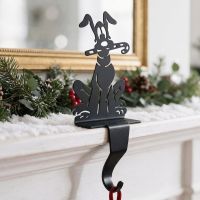 The Dog with Candy Cane Stocking Holder on the Edge of a Mantelpiece with Holly Behind it - Digital Illustration 