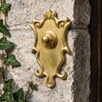 The “Dubrowe Park” Polished Brass Ornate Bell Push on a Wall next to Ivy and a Front Door - Digital Illustration The “Dubrowe Park” Polished Brass Ornate Bell Push on a Wall next to Ivy and a Front Door - Digital Illustration