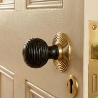 The Ebony Beehive door knobs With Polished Brass Rose on a Cream Door with Matching Brass Keyhole - Digital Illustration The Ebony Beehive door knobs With Polished Brass Rose on a Cream Door with Matching Brass Keyhole - Digital Illustration