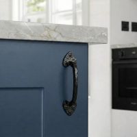 The Eight Inch "Merlino" Gothic Pull Handle Mounted on a Blue Cupboard door in a Contemporary Kitchen Setting - Digital Illustration 
