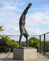 The Equilibrium Handstand Garden Sculpture in Verdigris Displayed on a Raised Plinth in a Modern Garden - Digital Illustration