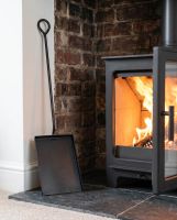 The Extra Long Fireside & Firepit Spade Tool in a Luxury Modern Home Next to a Fireplace - Digital Illustration 