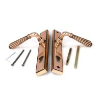 The Fluted Slimline Exterior Door Handle in a Polished Bronze Finish Shown with Both Front and Back with Fitting Screws The Fluted Slimline Exterior Door Handle in a Polished Bronze Finish Shown with Both Front and Back with Fitting Screws