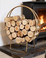 The Gold Finish Circular Log Rack & Holder Positioned next to a Log Burner Stove in a Country Cottage - Digital Illustration The Gold Finish Circular Log Rack & Holder Positioned next to a Log Burner Stove in a Country Cottage - Digital Illustration
