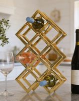 The Gold "Geometric" 9 Bottle Wine Rack on a Modern Kitchen Island next to a Wine Glass - Digital Illustration