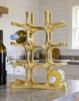 The Gold "Kempton House" Wine Rack Displayed in a Modern White Kitchen Next ot a Wine Bottle - Digital Illustration