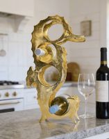 The Gold "Seahorse" Wine Rack Displayed next to a Bottle of Wine in a Luxury Kitchen - Digital Illustration The Gold "Seahorse" Wine Rack Displayed next to a Bottle of Wine in a Luxury Kitchen - Digital Illustration