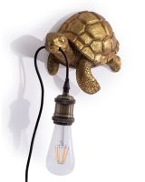 The Golden "Oceanic Guide" Turtle Wall Light Shown at an Angle on a White Background 