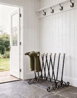 The Haldenwall 6 Pair Boot Rack in Black Placed in a Stone Tiled Cottage Porch - Digital Illustration The Haldenwall 6 Pair Boot Rack in Black Placed in a Stone Tiled Cottage Porch - Digital Illustration