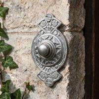 The “Hampern Close” Brushed Chrome Decorative Bell Push on a Grey Stone Wall next to the Front Door of a Home - Digital Illustration The “Hampern Close” Brushed Chrome Decorative Bell Push on a Grey Stone Wall next to the Front Door of a Home - Digital Illustration