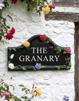 The Hand Painted Rose House Name Sign in a White Exterior Wall - Digital Illustration The Hand Painted Rose House Name Sign in a White Exterior Wall - Digital Illustration
