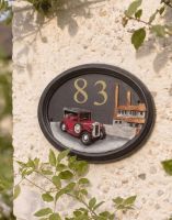 The Hand Painted Tin Lizzy Vintage Car House Sign with Custom Vinyl House Number on a Sunny Wall on the Side of a House - Digital Illustration The Hand Painted Tin Lizzy Vintage Car House Sign with Custom Vinyl House Number on a Sunny Wall on the Side of a House - Digital Illustration