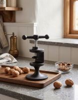 The “Hollybrock” Cast iron nutcracker next to a Kitchen Window next to Walnuts - Digital Illustration The “Hollybrock” Cast iron nutcracker next to a Kitchen Window next to Walnuts - Digital Illustration