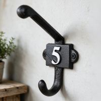 The Iron Coat Hook with Numbe 5 on it Placed Next to a Shelf on an Interior Wall - Digital Illustration The Iron Coat Hook with Numbe 5 on it Placed Next to a Shelf on an Interior Wall - Digital Illustration