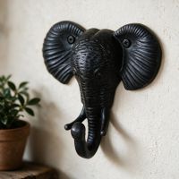 The Iron Elephant Coat Hook on a Cream Coloured Interior Wall next to a Plant - Digital Illustration The Iron Elephant Coat Hook on a Cream Coloured Interior Wall next to a Plant - Digital Illustration