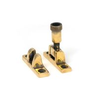 The Knurled Brighton Sash Square Window Fastener - Aged Brass on a White Background The Knurled Brighton Sash Square Window Fastener - Aged Brass on a White Background