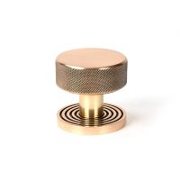 The Knurled Mortice/Rim Knob Set on a Beehive Rose in Polished Bronze Shown Upright on a White Background The Knurled Mortice/Rim Knob Set on a Beehive Rose in Polished Bronze Shown Upright on a White Background