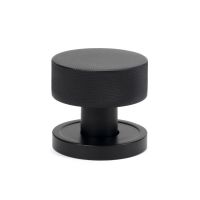 The Knurled Mortice/Rim Knob Set on a Plain Rose in Matt Black Shown Upright on a White Background The Knurled Mortice/Rim Knob Set on a Plain Rose in Matt Black Shown Upright on a White Background