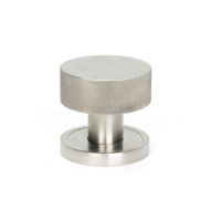The Knurled Mortice/Rim Knob Set on a Plain Rose in Satin Stainless Steel Shown Upright on a White Background The Knurled Mortice/Rim Knob Set on a Plain Rose in Satin Stainless Steel Shown Upright on a White Background