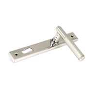 The Knurled Slimline Lever Espagnolette Door Handle Set in Polished Stainless Steel Shown Lying it on its Side on a White Background