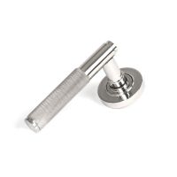 The Knurled Sprung Handle Set on a Round Rose in Polished Stainless Steel Shown at an Angle on a White Background