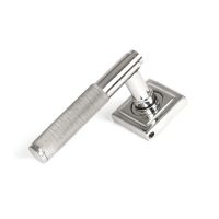 The Knurled Sprung Handle Set on a Square Rose in Satin Stainless Steel Shown at an Angle on a White Background