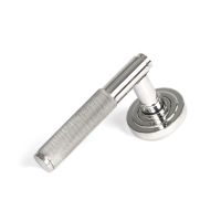 The Knurled Sprung Handle Set on an Art Deco Rose in Polished Stainless Steel Shown at an Angle on a White Background