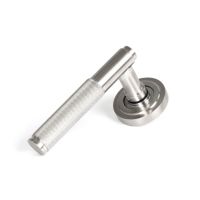 The Knurled Sprung Handle Set on an Art Deco Rose in Satin Stainless Steel Shown at an Angle on a White Background