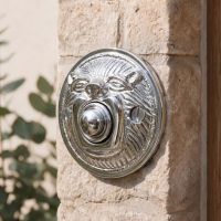 The “Lambeth Hall” Bright Chrome Round Lion Bell Push on a White Stone Wall at the Front of a Country Cottage - Digital Illustration The “Lambeth Hall” Bright Chrome Round Lion Bell Push on a White Stone Wall at the Front of a Country Cottage - Digital Illustration