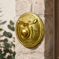 The “Lambeth Hall” Polished Brass Round Lion Bell Push on a Sunny Stone Wall next to a Front Door - Digital Illustration 