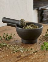 The Large Cast Iron “Amberden Grind” Mortar and Pestle on a Wooden Kitchen Worktop with Herbs - Digital Illustration
