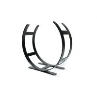 The Large Curved Fireside Log Holder in Matt Black Shown from an Angle on a White Background