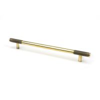 The Large Half Knurled Cabinet Pull Handle in Aged Brass Shown Upright on a White Background