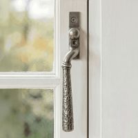 The Right Hand 16mm Hammered Pewter Espagnolette Window Handle on a White Painted Window Frame - Digital Illustration The Right Hand 16mm Hammered Pewter Espagnolette Window Handle on a White Painted Window Frame - Digital Illustration