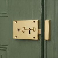 The Left Handed "Castille" Large Solid Brass Rim Lock Mounted on a Green Wooden Door - Digital Illustration The Left Handed "Castille" Large Solid Brass Rim Lock Mounted on a Green Wooden Door - Digital Illustration
