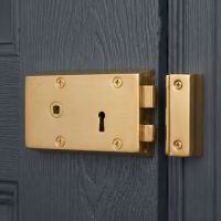 The Left Handed "Fabius" Large Polished Brass Rim Lock on a Blue Wooden Door - Digital Illustration The Left Handed "Fabius" Large Polished Brass Rim Lock on a Blue Wooden Door - Digital Illustration