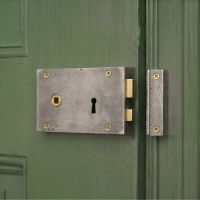 The Left Handed "Olini" Large Iron Rim Lock Securing a Green Wooden Door - Digital Illustration The Left Handed "Olini" Large Iron Rim Lock Securing a Green Wooden Door - Digital Illustration